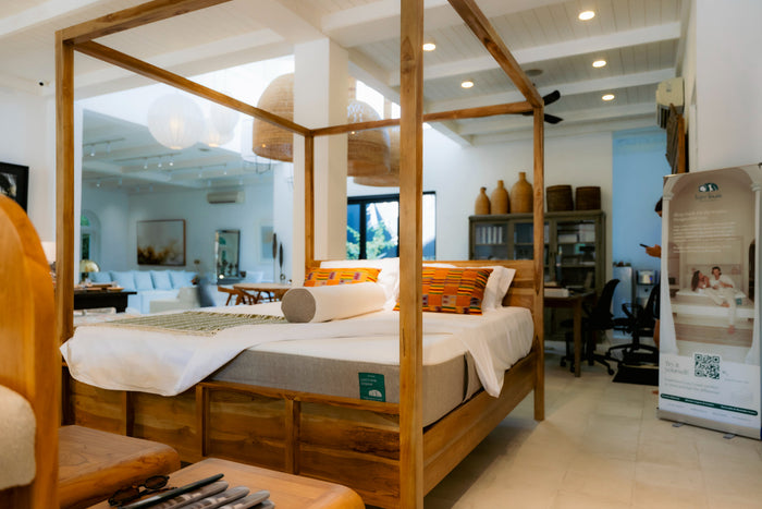 A made double bed in a styled Bali bedroom